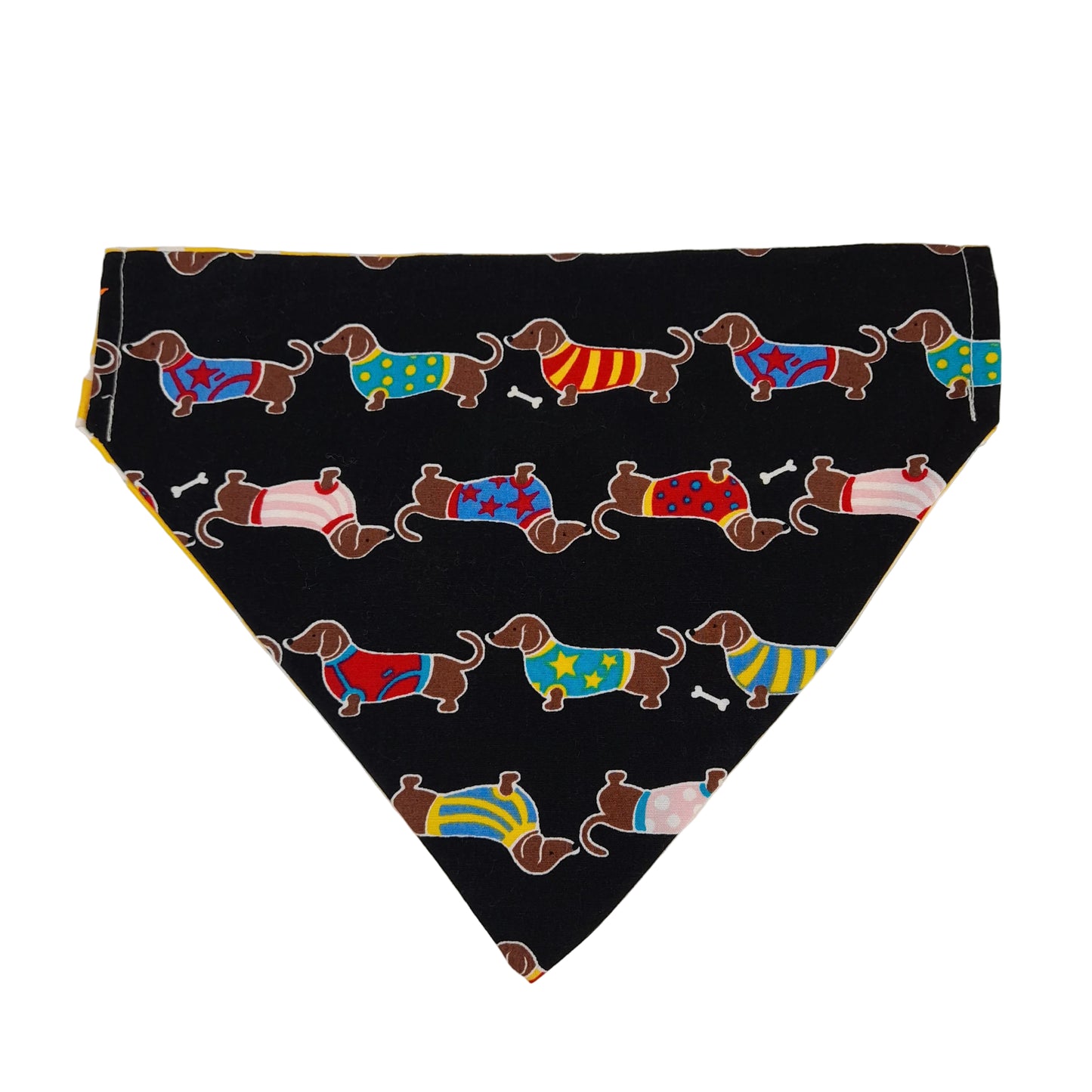 A triangular pet bandana or scarf laid flat on a light background, featuring a black base with a repeating pattern of dachshund dogs wearing colorful sweaters.