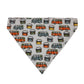 A triangular bandana-style pet collar or scarf made of white fabric with an all-over print of retro patterned campervans in orange, green, blue, and yellow, photographed flat against a light gray background.